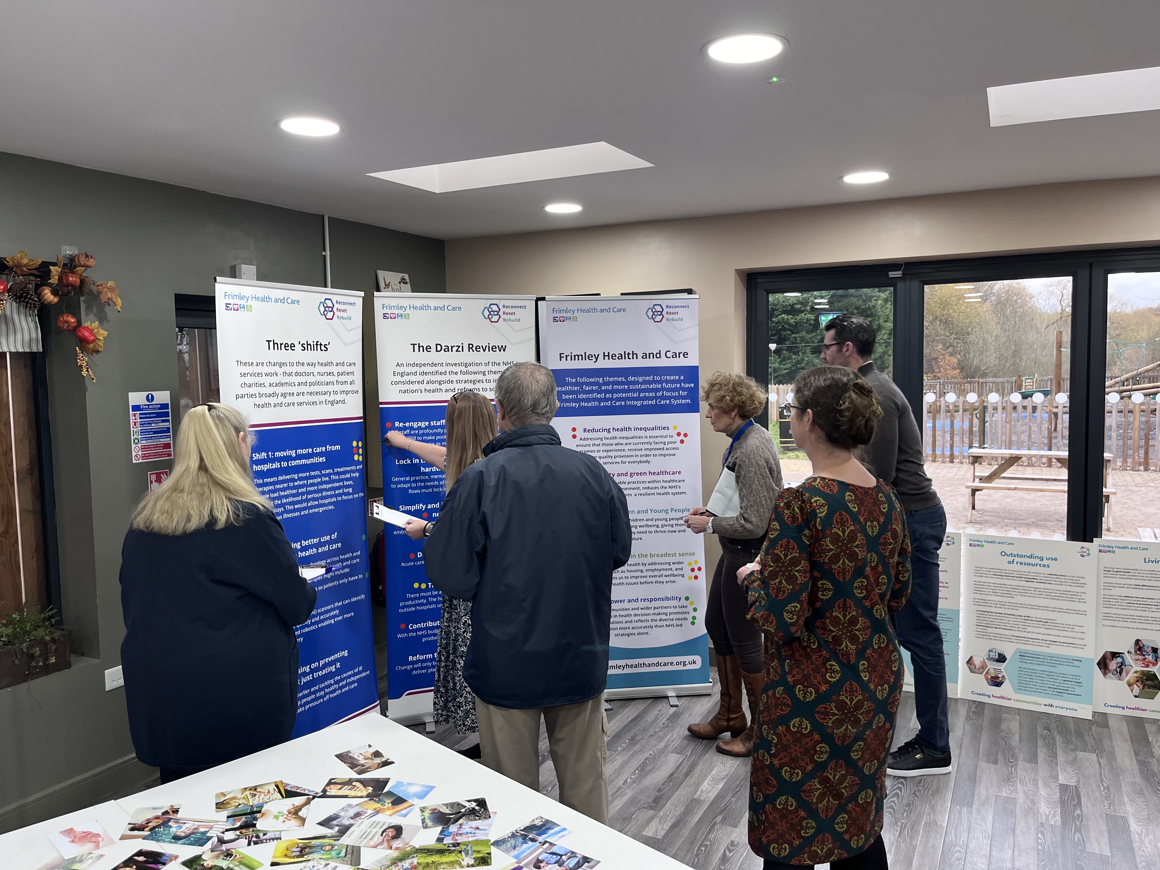 Group of people looking at pull up banners and sticking stickers on the relevant categories